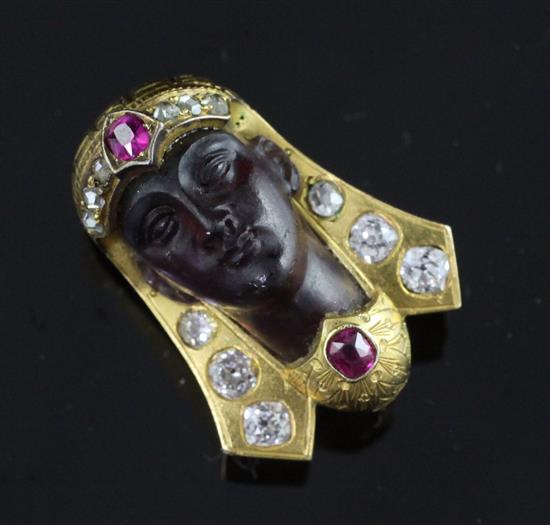 A late 19th/early 20th century gold, ruby, diamond and amethyst glass? clip brooch, modelled as the head of a Pharaoh, 22mm.